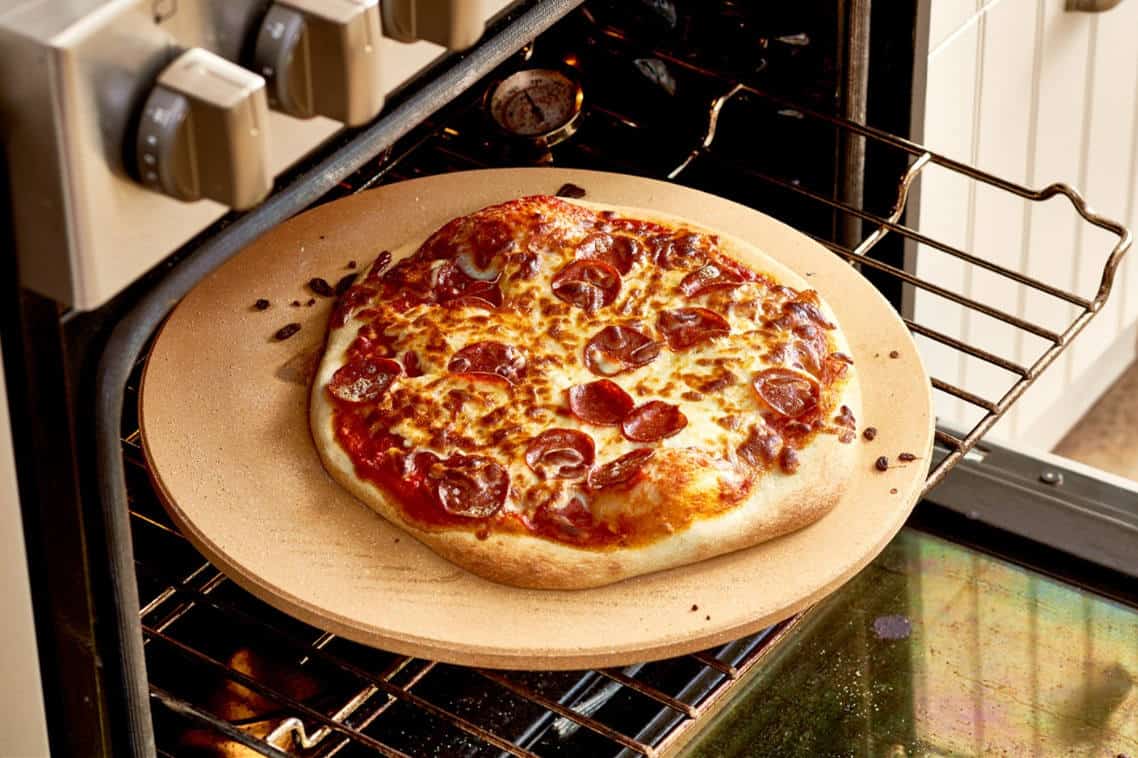 how to transfer pizza from peel to stone